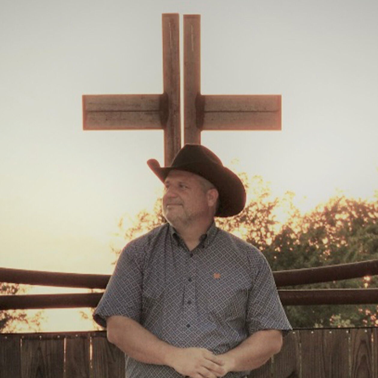 Brett standing in front of a cross